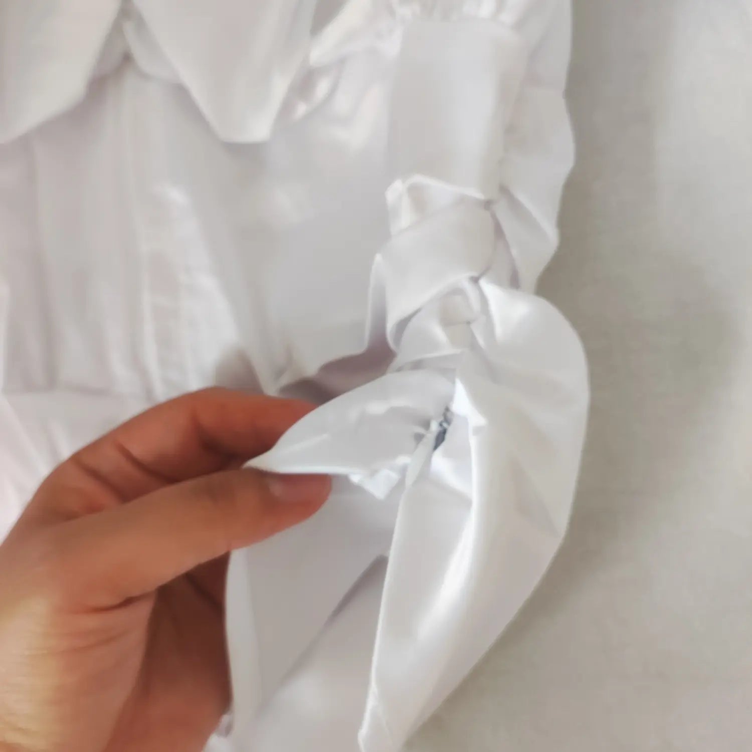 Macro closeup side ruched seam detail adjustable drawstring blouse