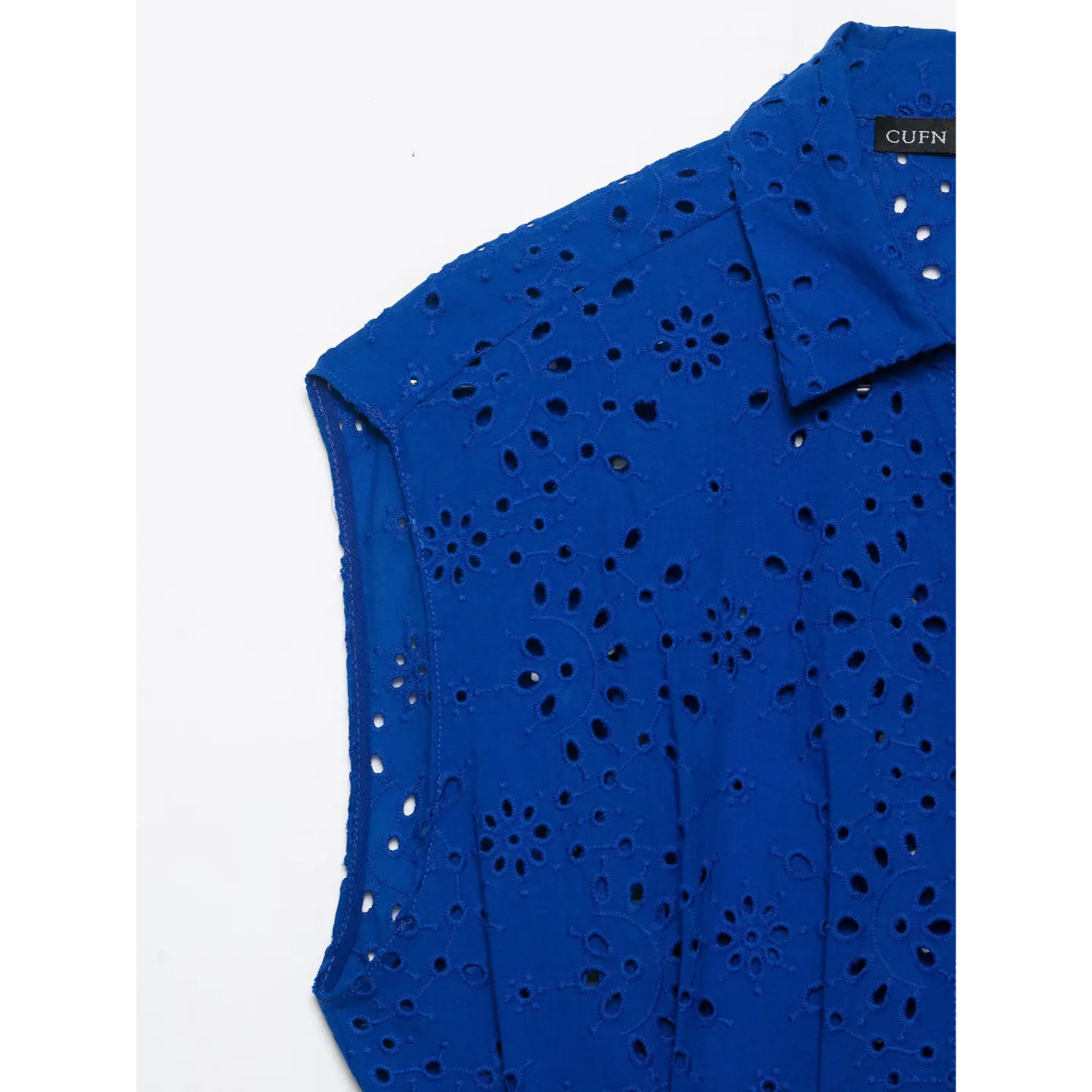 Armhole and shoulder fabric close-up of cobalt blue floral eyelet sleeveless top
