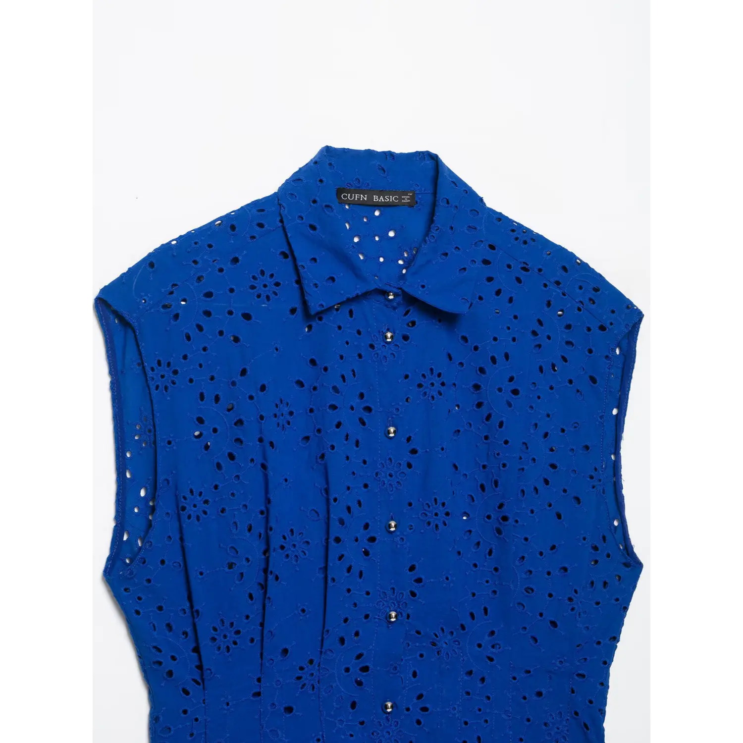 Upper front flat lay view, collar and metal button placket of cobalt blue eyelet sleeveless blouse