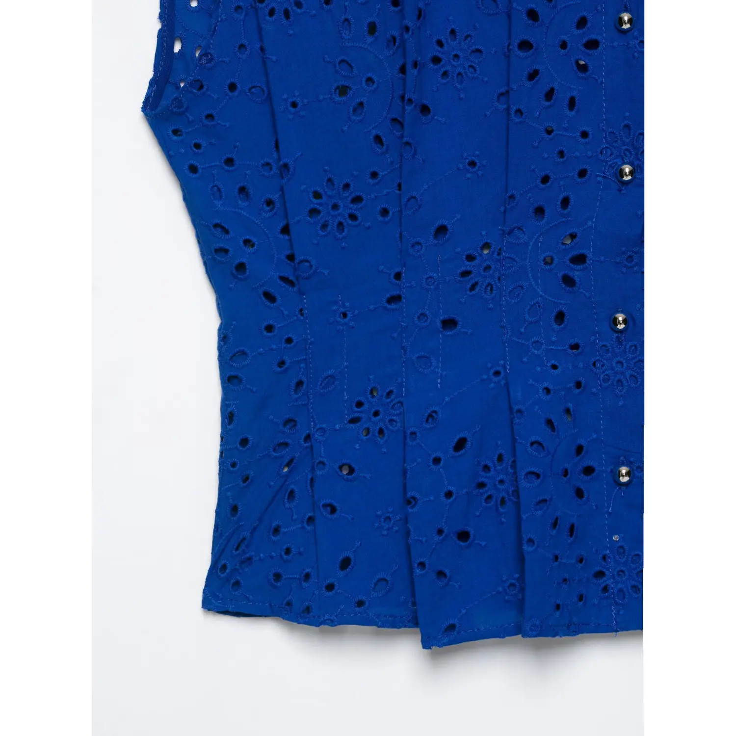 Hem and side eyelet fabric close-up of cobalt blue floral eyelet sleeveless collared shirt
