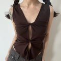 Coffee double knot v-neck sleeveless tank front indoor model shot, bust double twist cutout stretch knit slim cropped uneven hem, matched with grey low waist pants cool hot girl outfit display