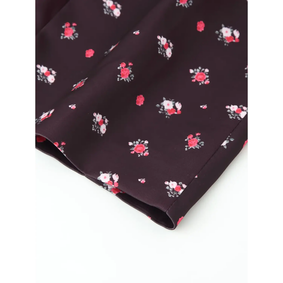 Close‑up finished hem edge of coffee ditsy rose floral maxi dress