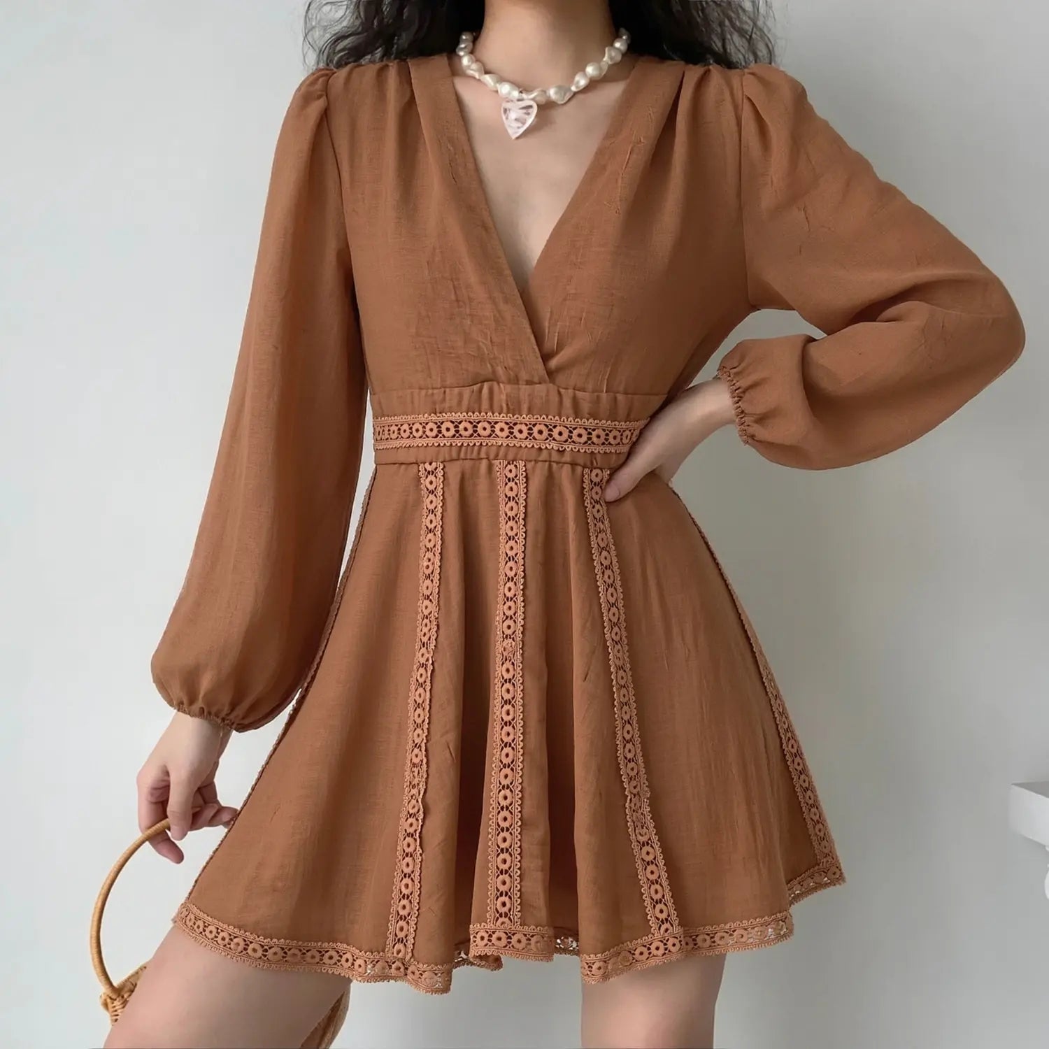 Model front lifestyle wearing shot, show real fit of coffee hollow lace trim long sleeve mini dress