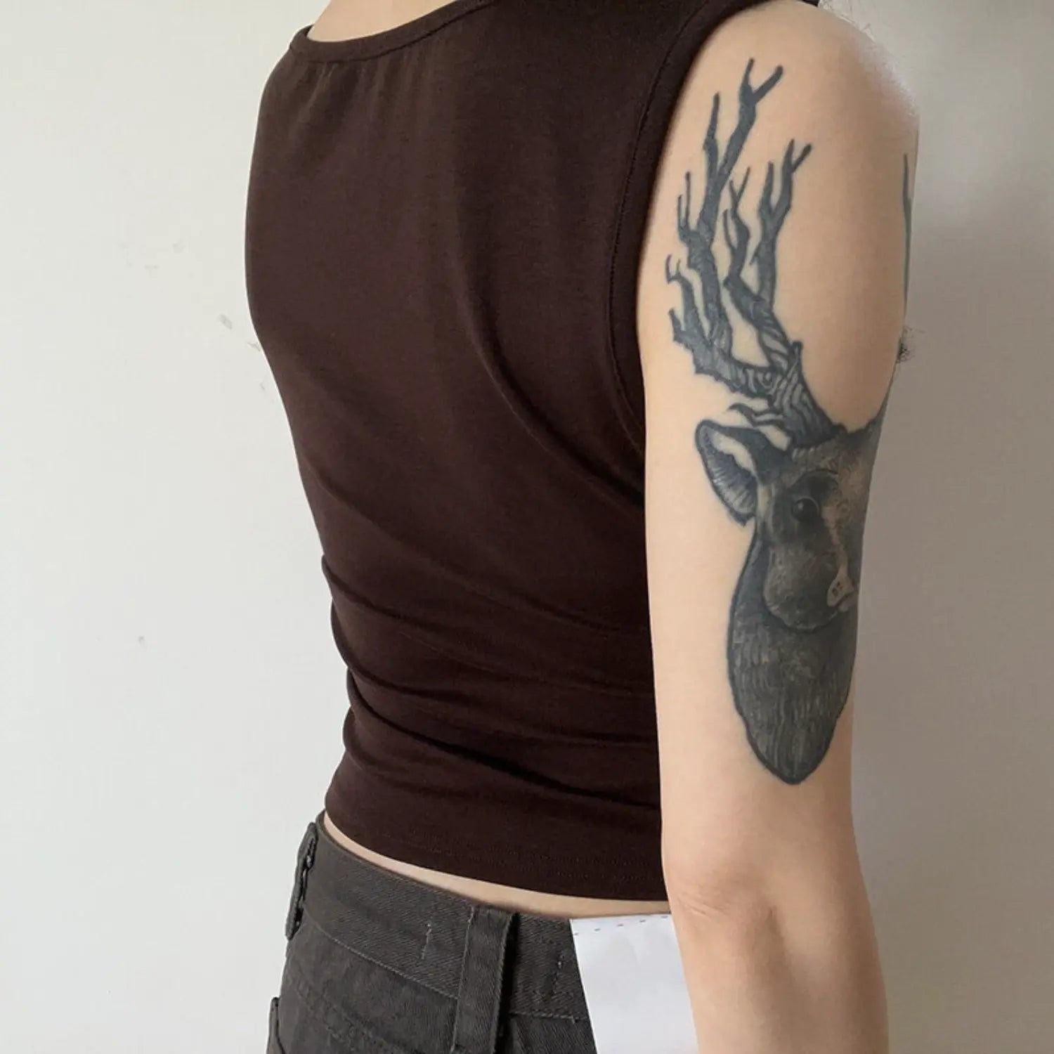 Coffee sleeveless double twist tank full back model shot, solid knit plain back ruched cropped fit, matched with grey casual trousers minimalist commuter outfit