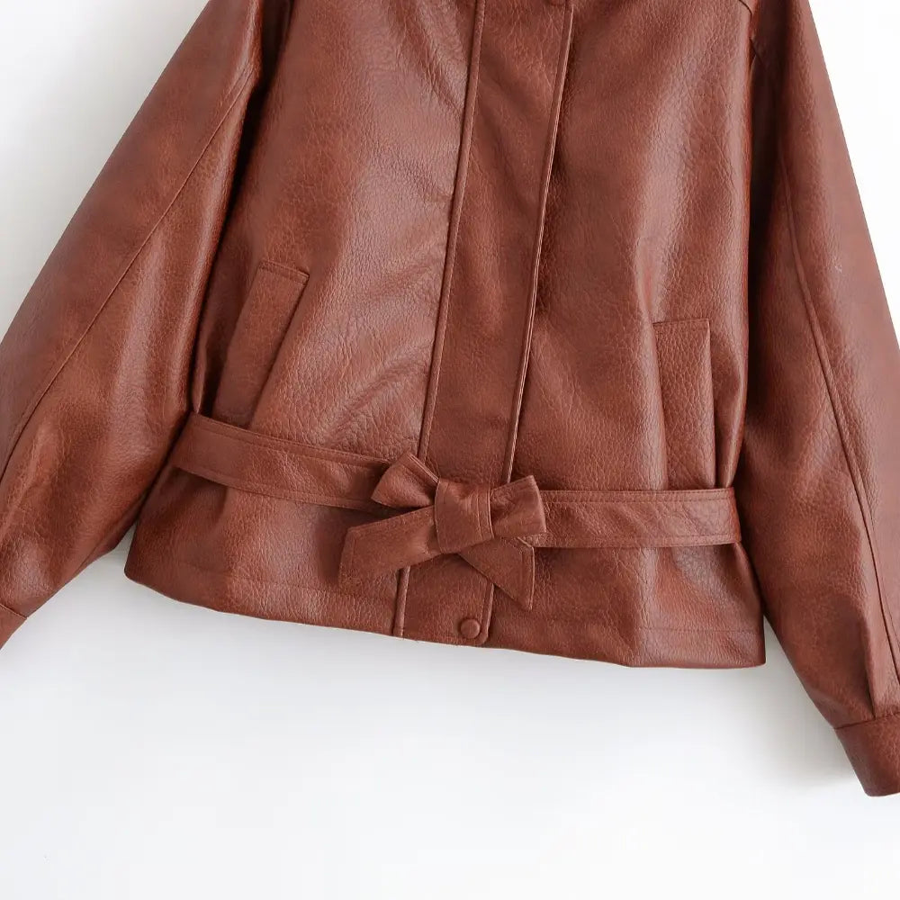 Close-up of self-tie bow belt and welt pockets