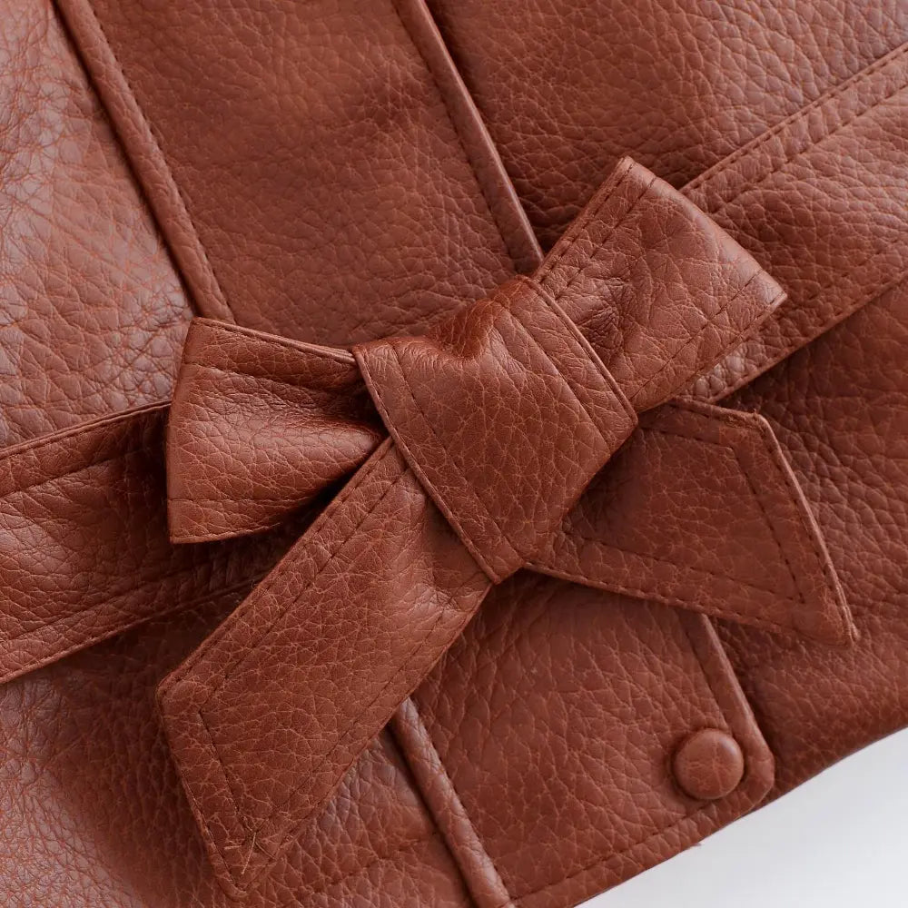 Close-up of leather bow knot and stitching