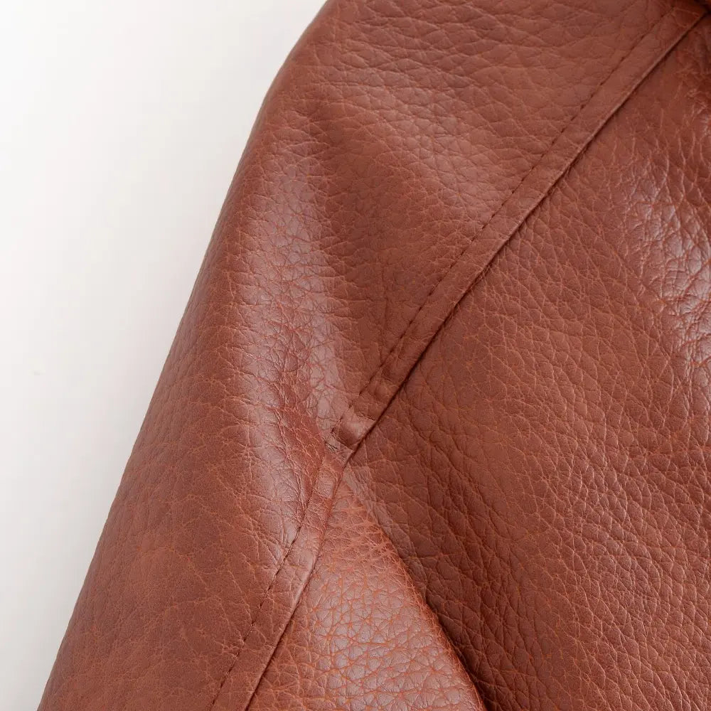 Close-up of shoulder seam and faux leather grain