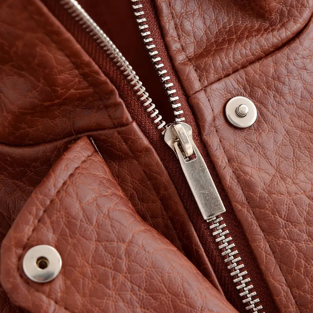 Close-up of silver zipper teeth and snap button