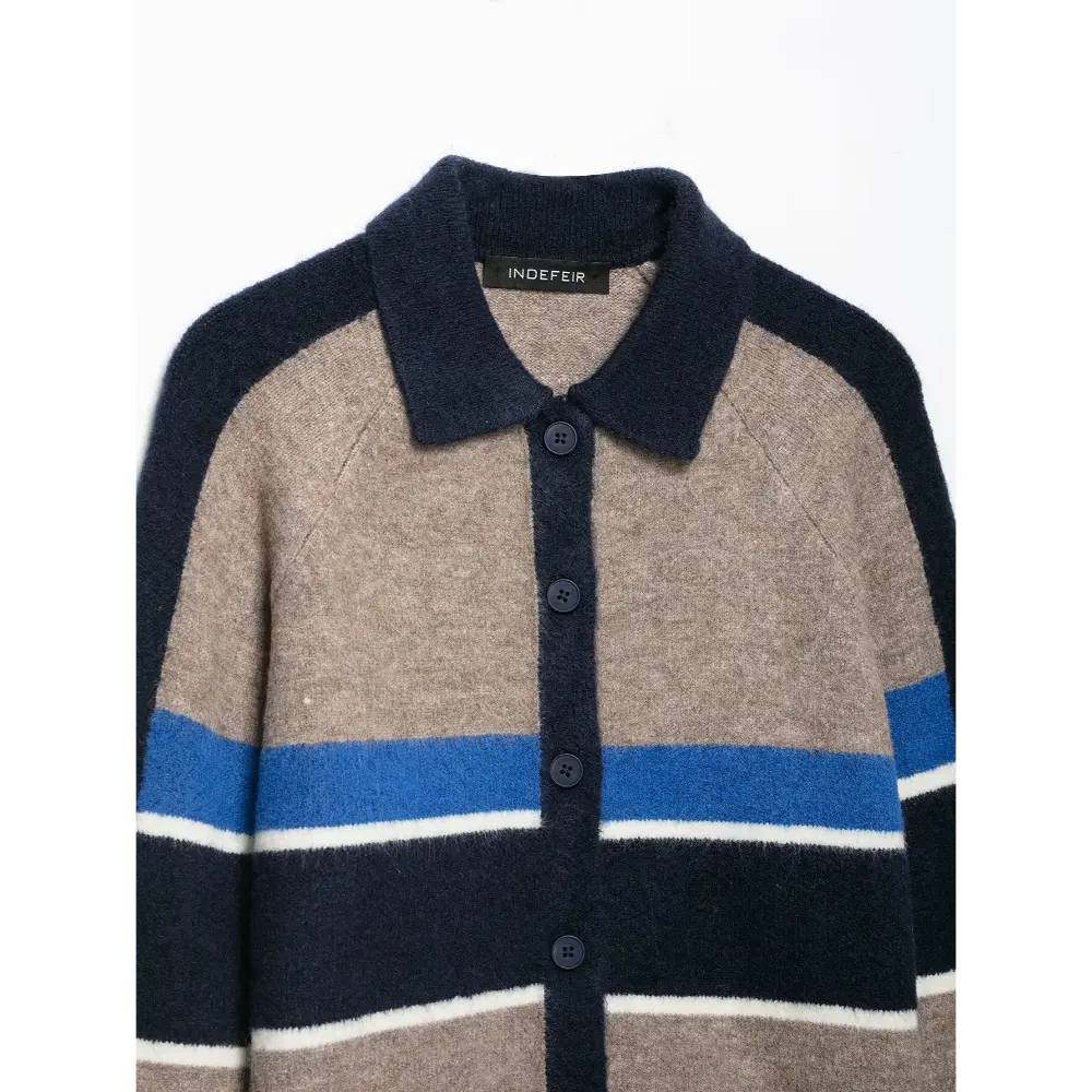 Close-up of polo collar and navy button placket