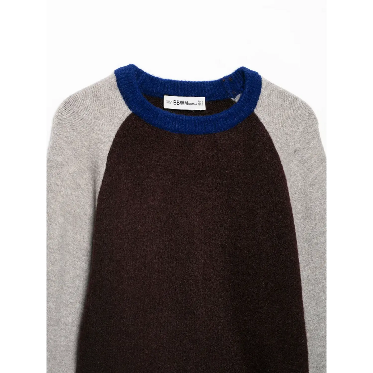 Close-up of blue ribbed crew neck and label