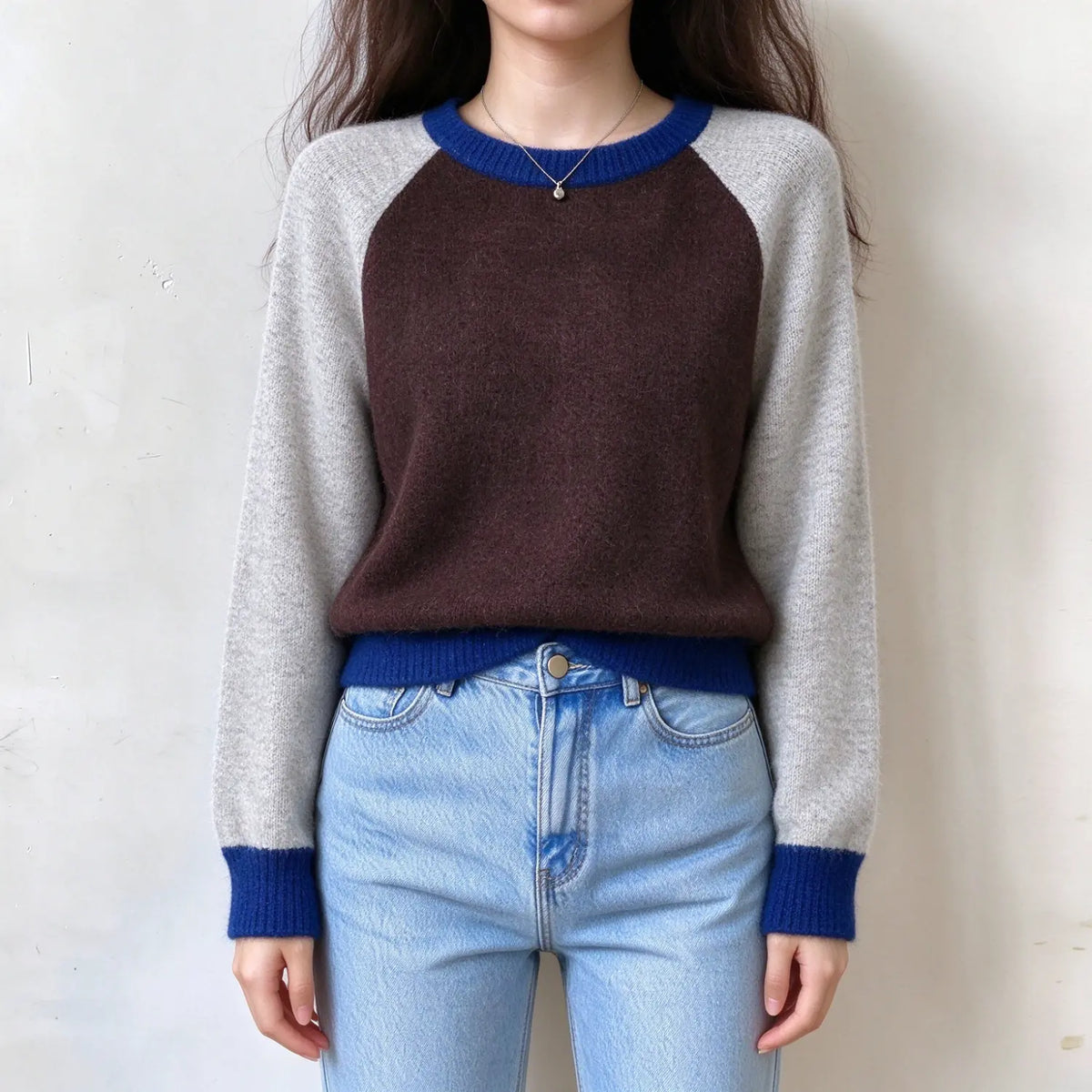 Model wearing colorblock raglan sleeve crew neck sweater, front view