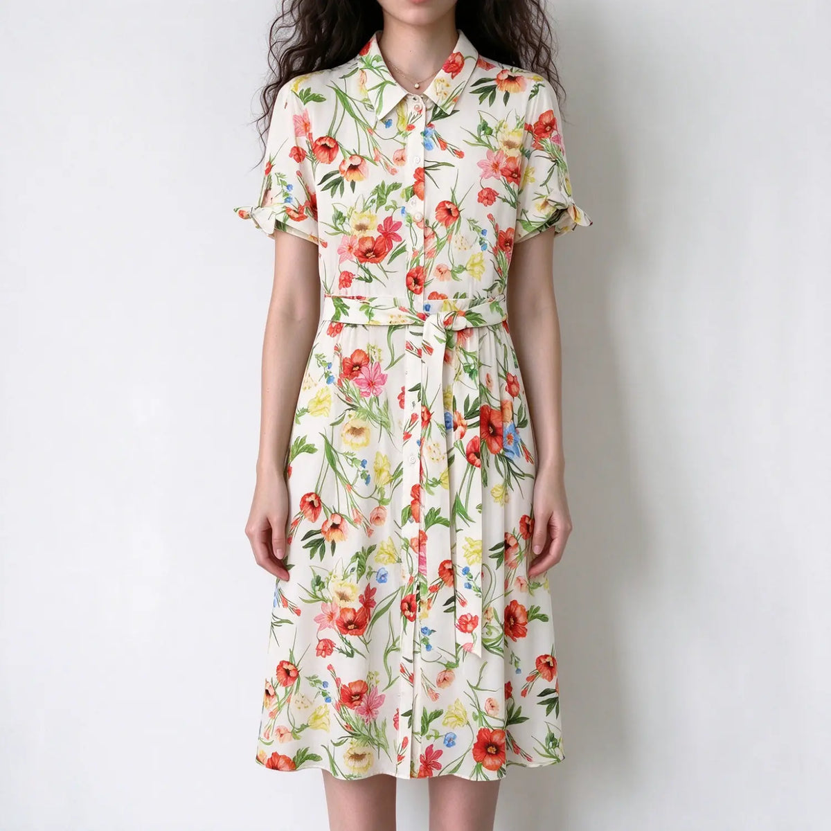 Female model front view wearing white base colorful floral shirt midi dress, collared neck, short ruffle sleeves, self tie waist belt, long midi skirt