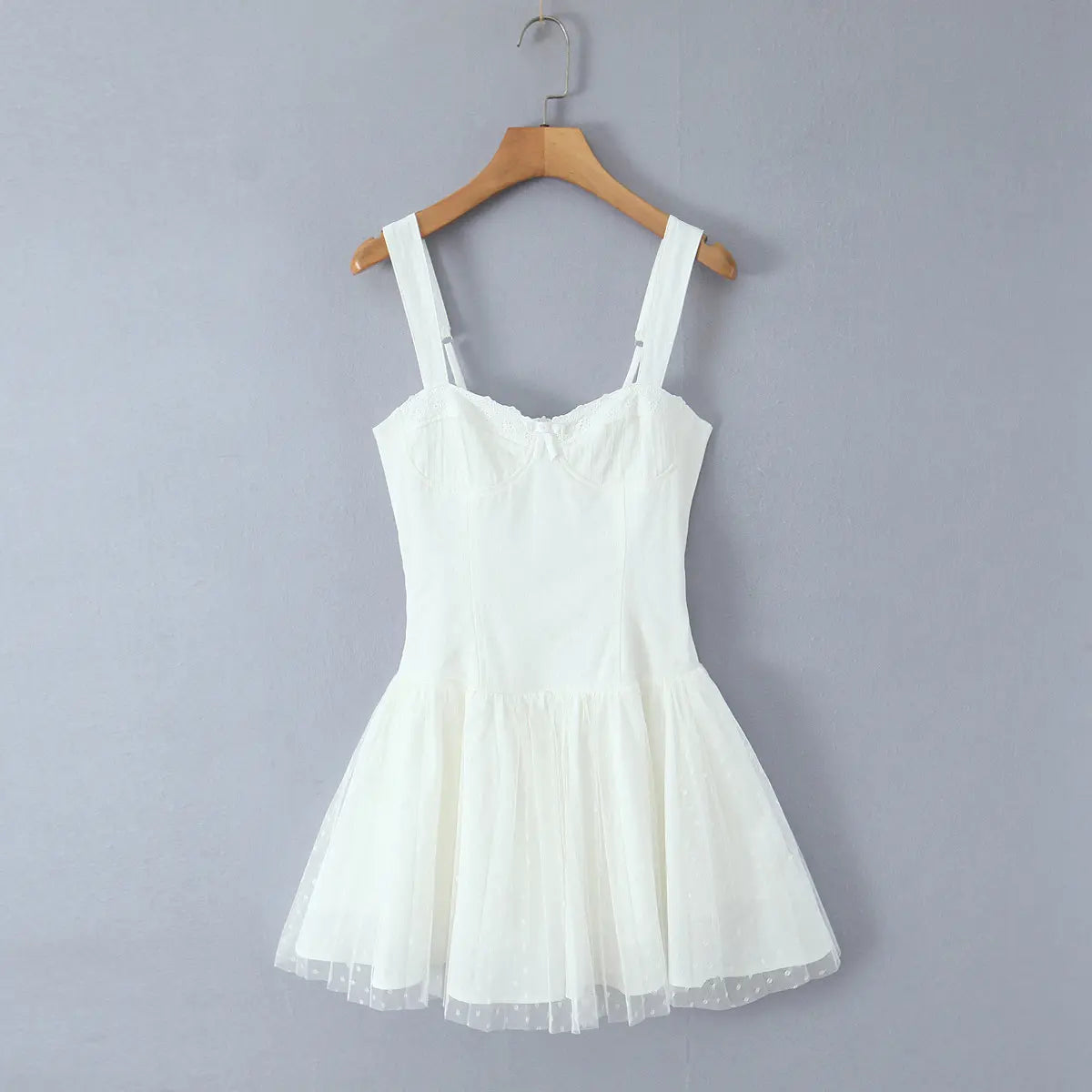 Front hanging apparel photo, sweet coquette design with lace trim bust, structured corset waist and airy dotted tulle flare skirt.