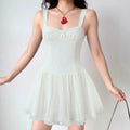 Full body standing lifestyle photo of ivory lace trim corset mini dress, adjustable wide straps and voluminous dotted tulle skirt, sweet balletcore outfit.