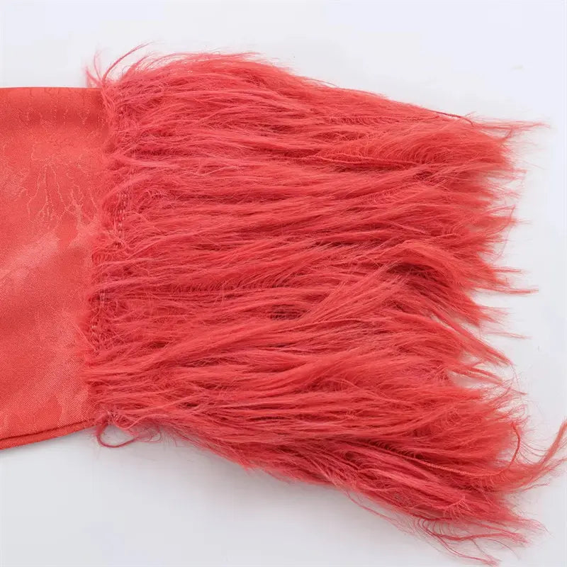 Macro closeup long fluffy coral red fringe tassel sleeve cuff, soft shaggy faux fur fringe trim, matching peony jacquard fabric base stitching