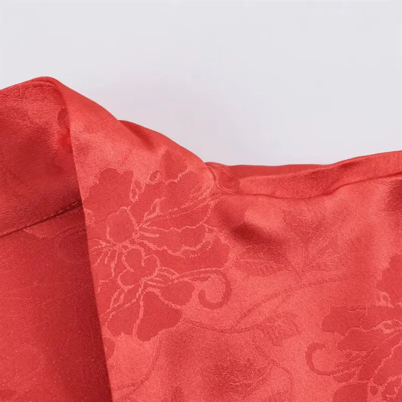Front cross wrap draped fabric closeup, soft shiny satin jacquard with allover peony pattern