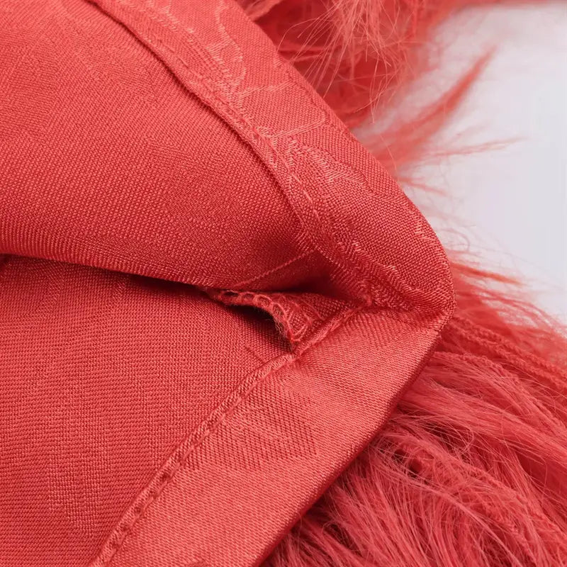 Macro closeup pant ankle hem corner stitching, coral red peony jacquard satin fabric, secure seam connecting long fluffy tassel fringe trim, neat folded edge workmanship