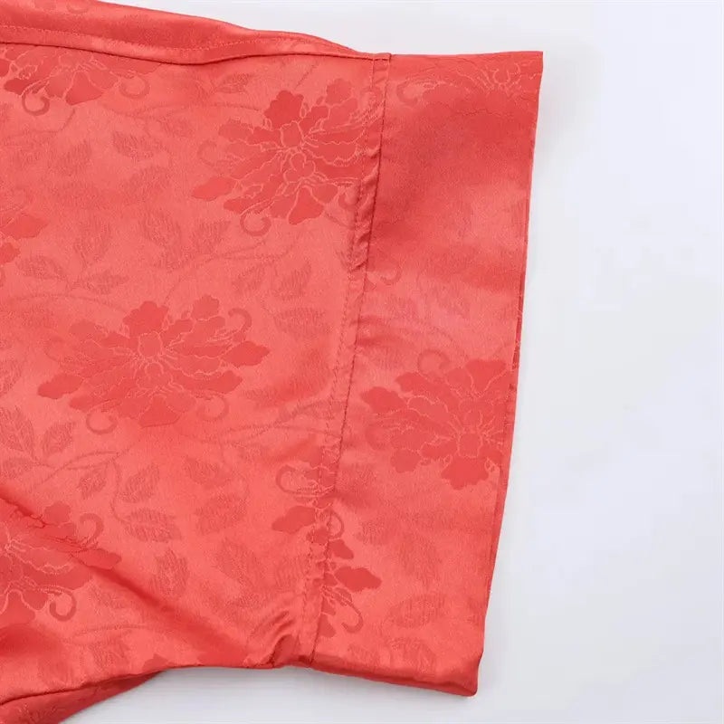 Full bottom hem edge closeup, neat folded finished stitching on mid-length loose outer coat