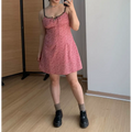 Indoor mirror selfie full shot of pink tiny floral mini slip dress, black lace scallop bust trim, front thin tie bow, styled with gray ankle socks and black platform loafers