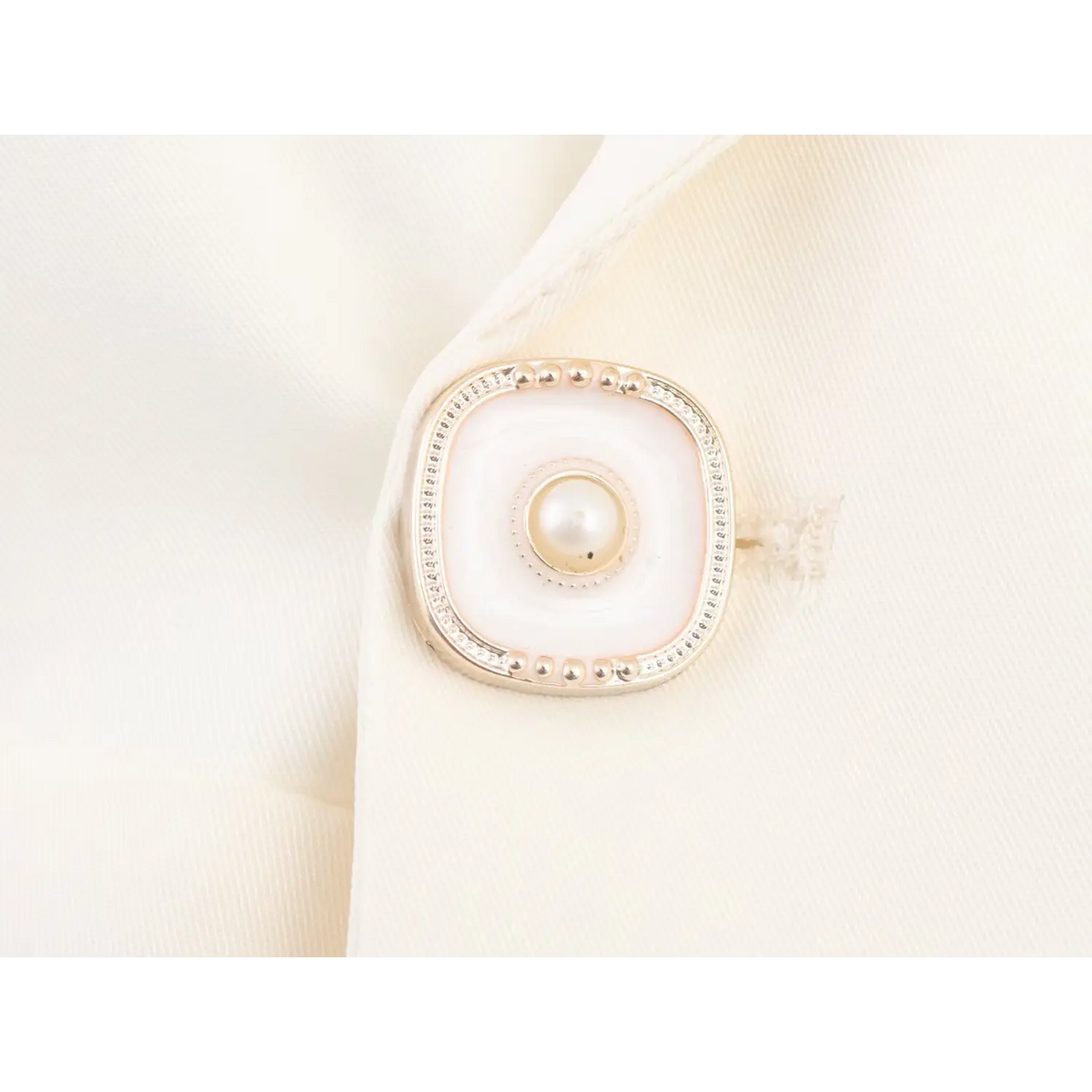 Close-up of pearl gold trim button