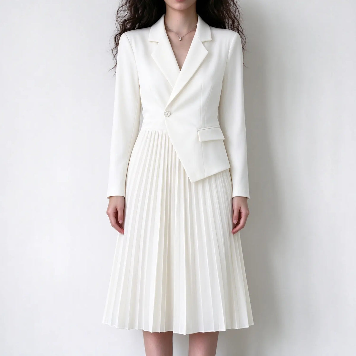 Model wearing cream asymmetric blazer pleated midi dress, front view
