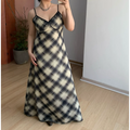 Plain front indoor mirror full shot of lightweight sheer plaid maxi slip dress, thin spaghetti straps with black contrast binding, V-neck mini fabric bow, bias cut flowy floor-length skirt, soft sheer chiffon texture, neutral minimalist room background