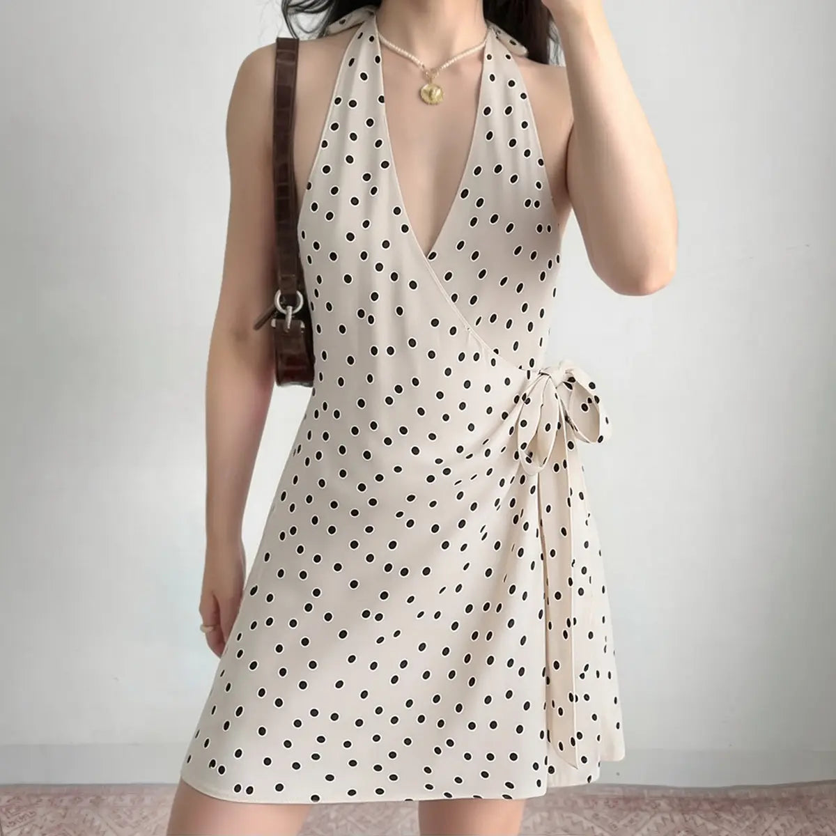 The halter wrap dress styled on a model, showcasing its deep V-neckline, wrap silhouette, and the way the fabric drapes.