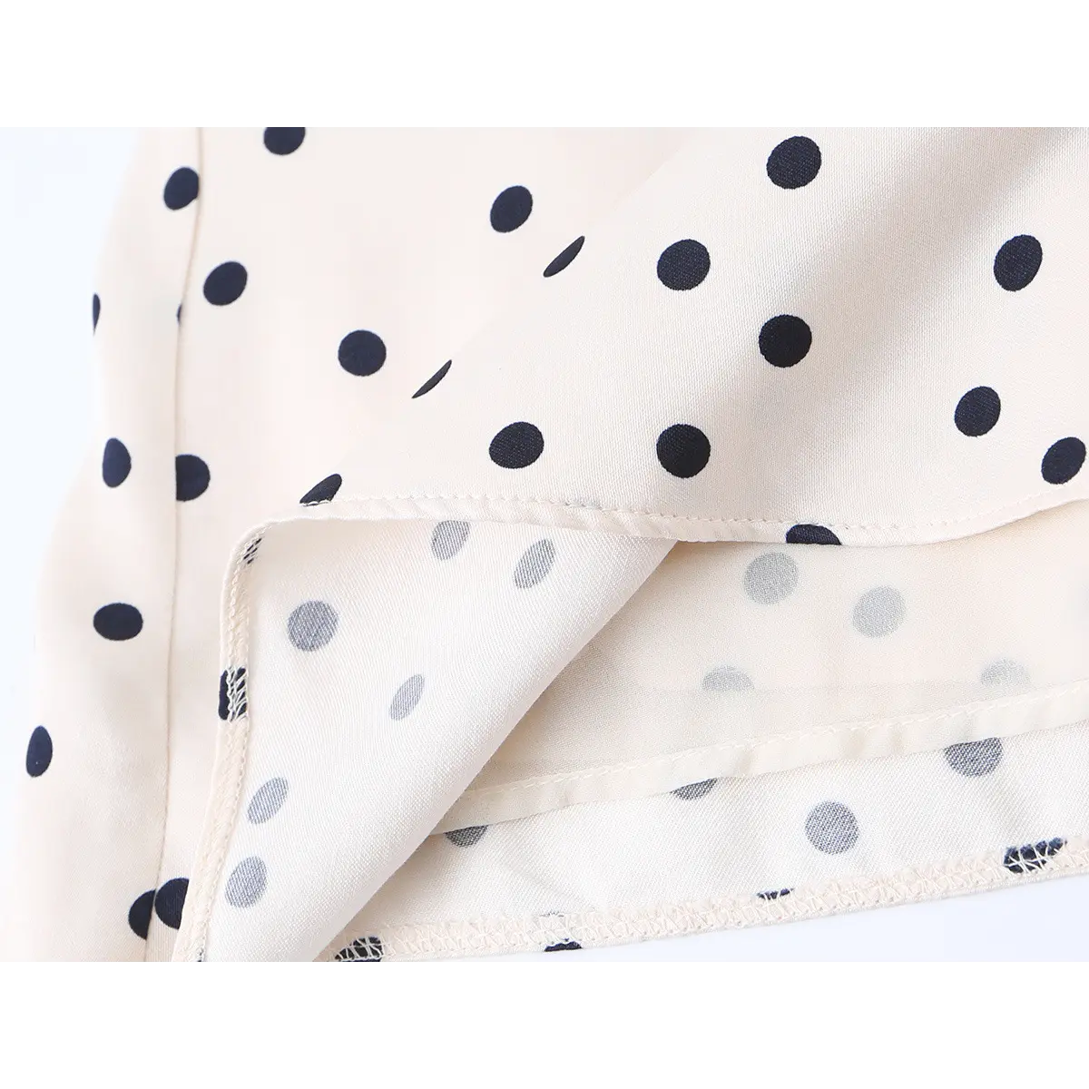 Close-up of the dress's seam, showing the construction and the contrast between the outer fabric and the lining.
