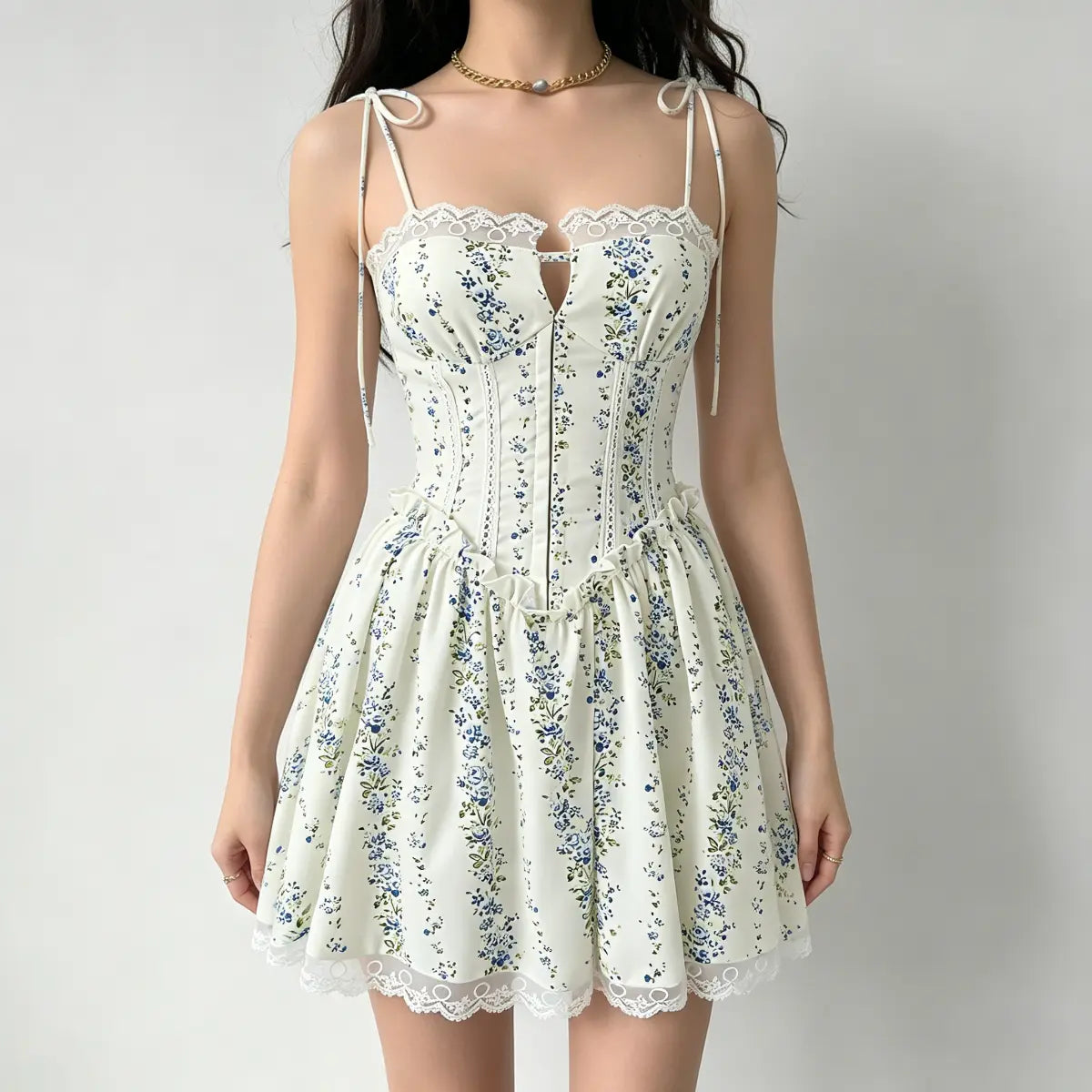 Full front view of a model wearing a cream blue floral corset dress, showing the lace neckline and flared skirt.