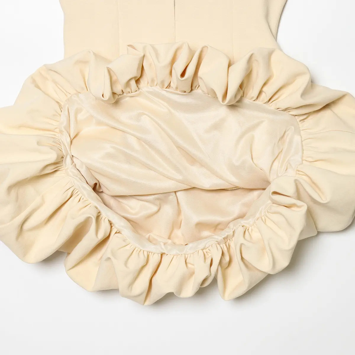 Close-up of the bubble hem, showing the gathered construction and inner lining.
