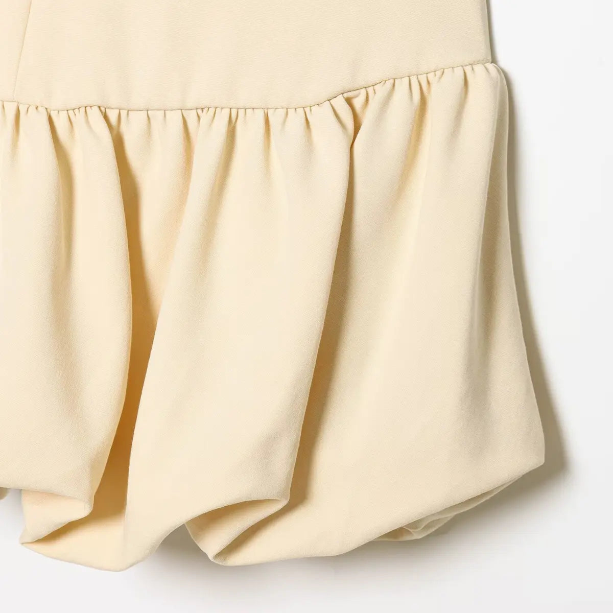 Close-up of the gathered bubble hem fabric and construction.