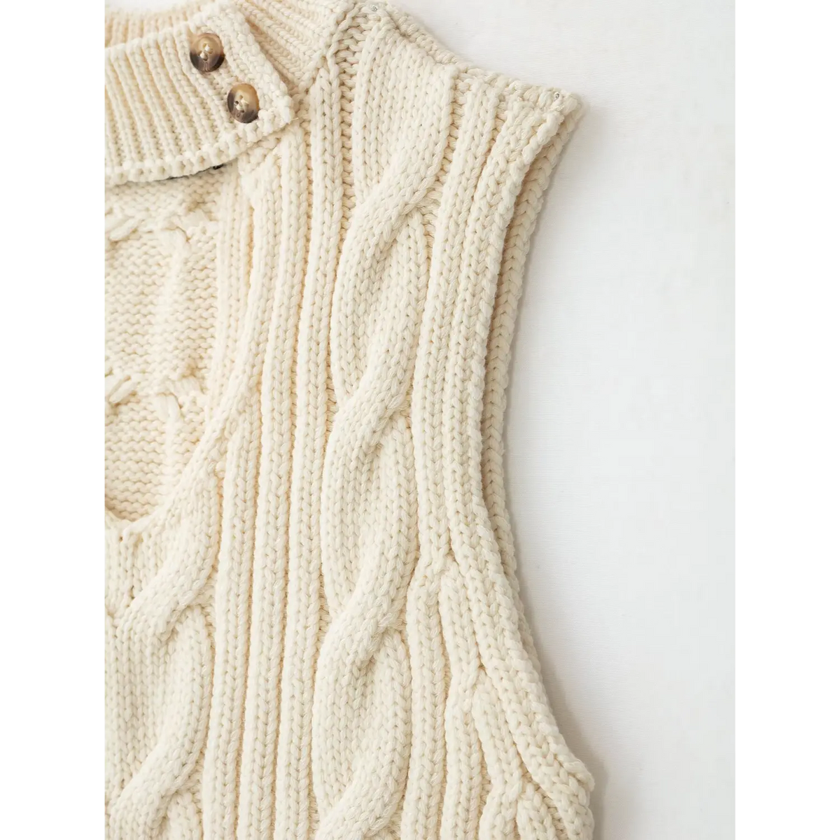 Close-up of side buttons and armhole stitching