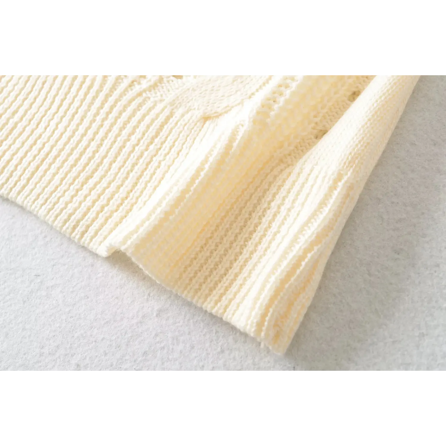 Close view of stretch ribbed bottom hem cream hollow cable knit slim women short sleeve knit top
