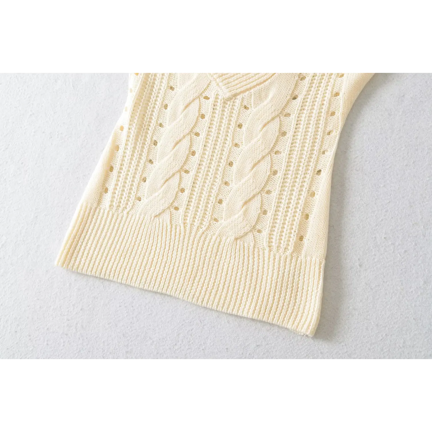 Cream cable knit hollow out ribbed hem close up shot of women v neck short sleeve knit top fabric texture