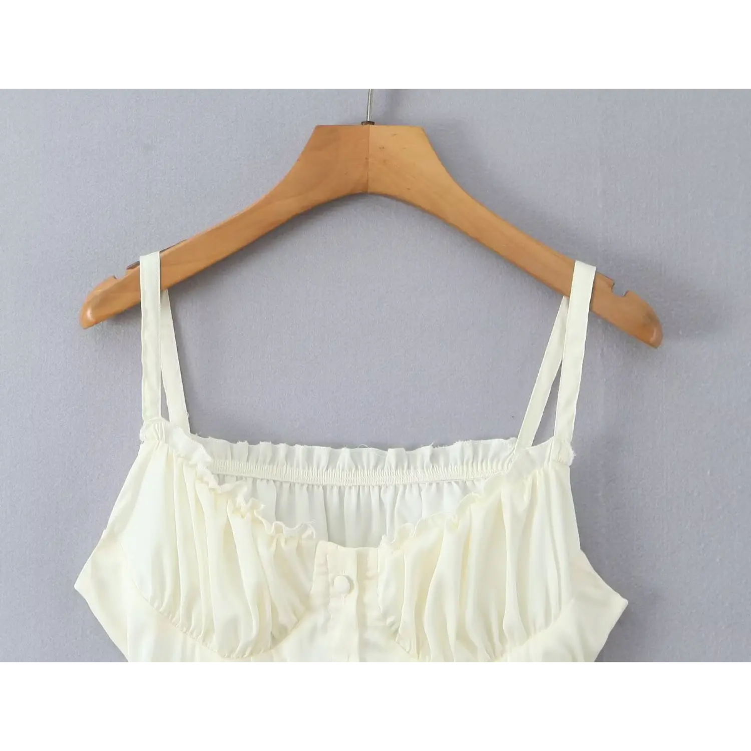 Close‑up ruffle neckline and ruched bust detail cream cami mini dress front button placket