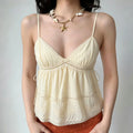 Model wearing cream lace babydoll cami top, v neck, side drawstring and vintage floral embroidery