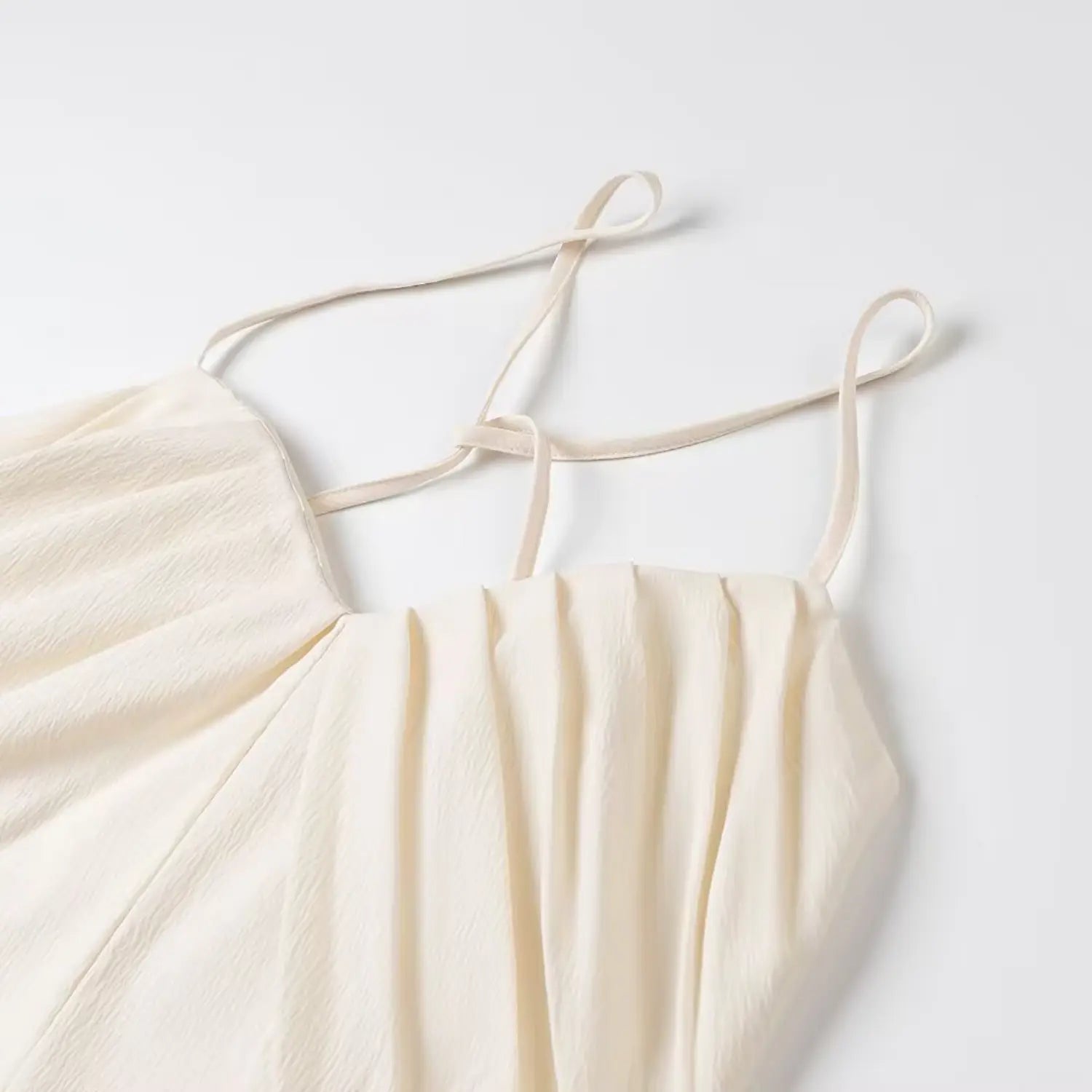 Close-up adjustable thin spaghetti straps cream ruched cami crop top