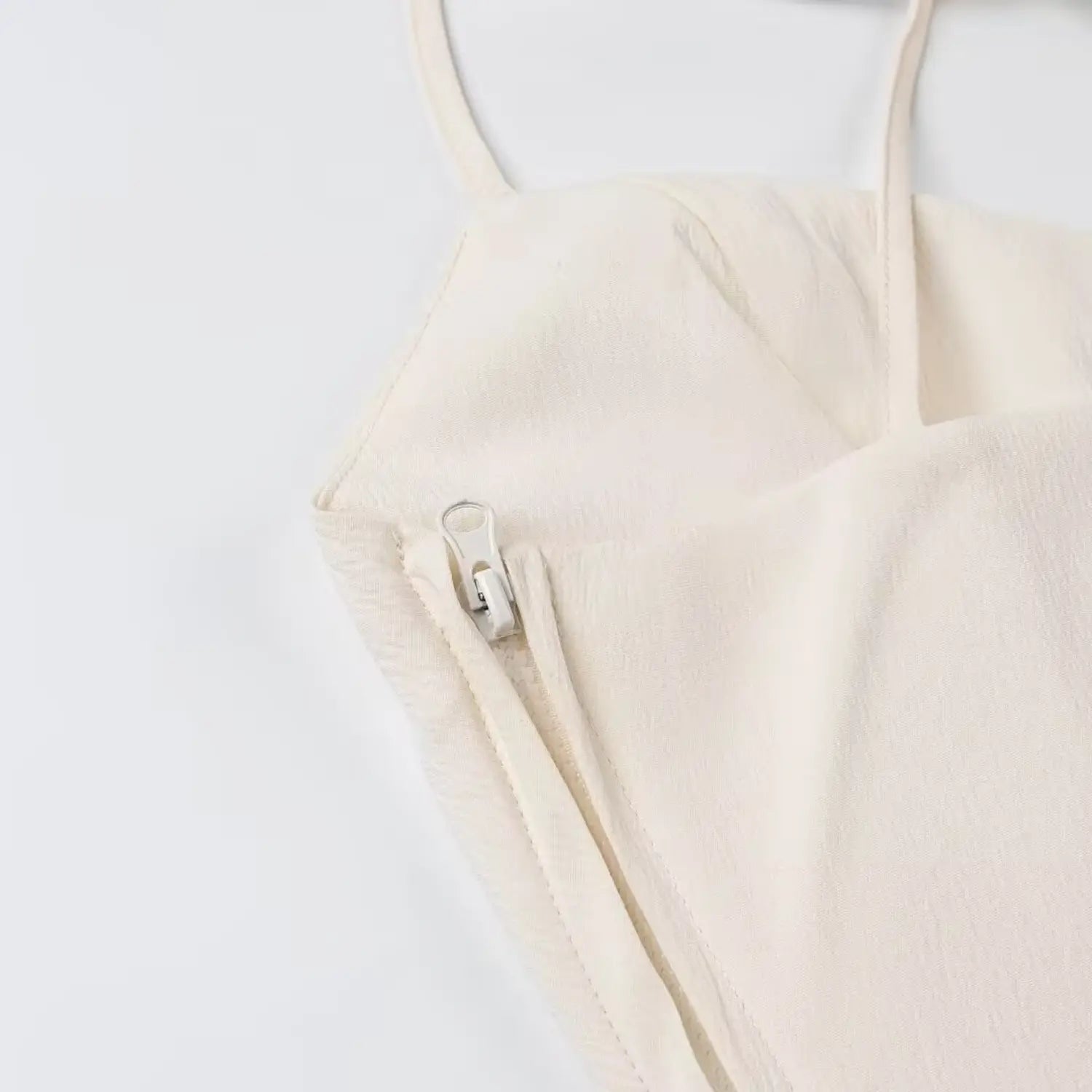 Invisible side zipper close-up cream spaghetti strap cropped cami top