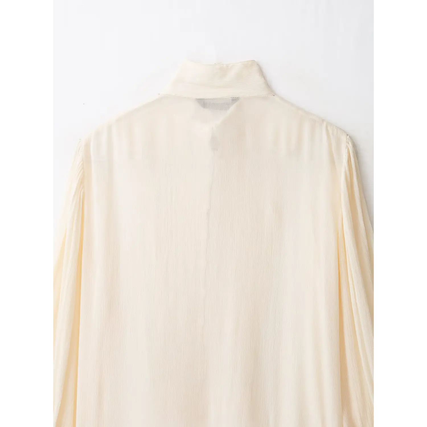 Back stand collar close‑up, sheer crinkled chiffon fabric texture of cream blouse