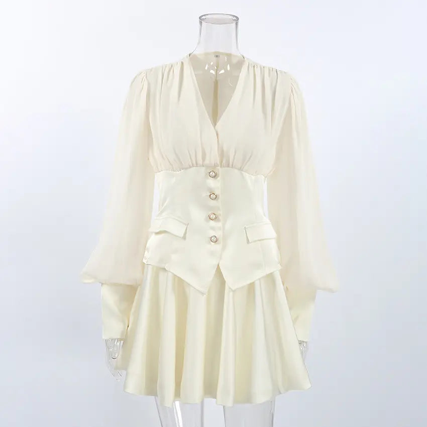 Cream chiffon bodice pearl button waist mini dress on mannequin, front view