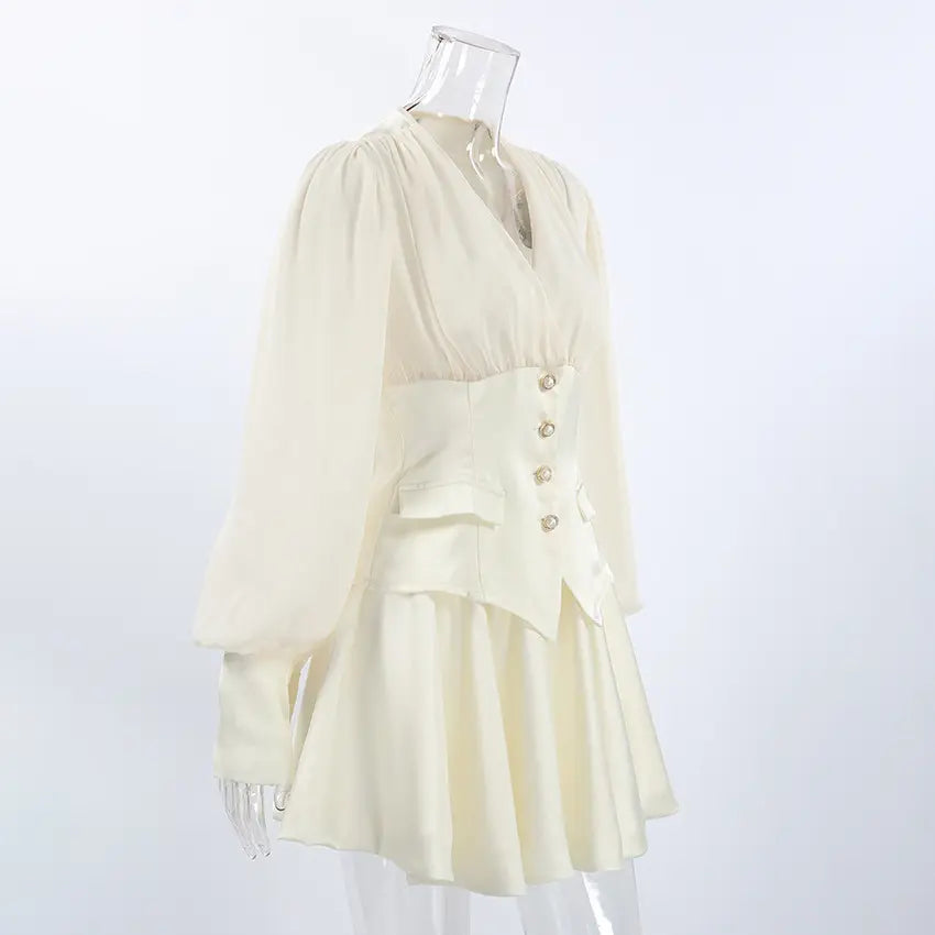 Cream chiffon bodice pearl button waist mini dress on mannequin, three quarter view