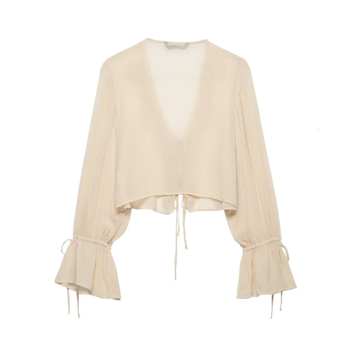 Back view of a cream chiffon blouse, showing the semi-sheer fabric, cropped silhouette, and unadorned back.