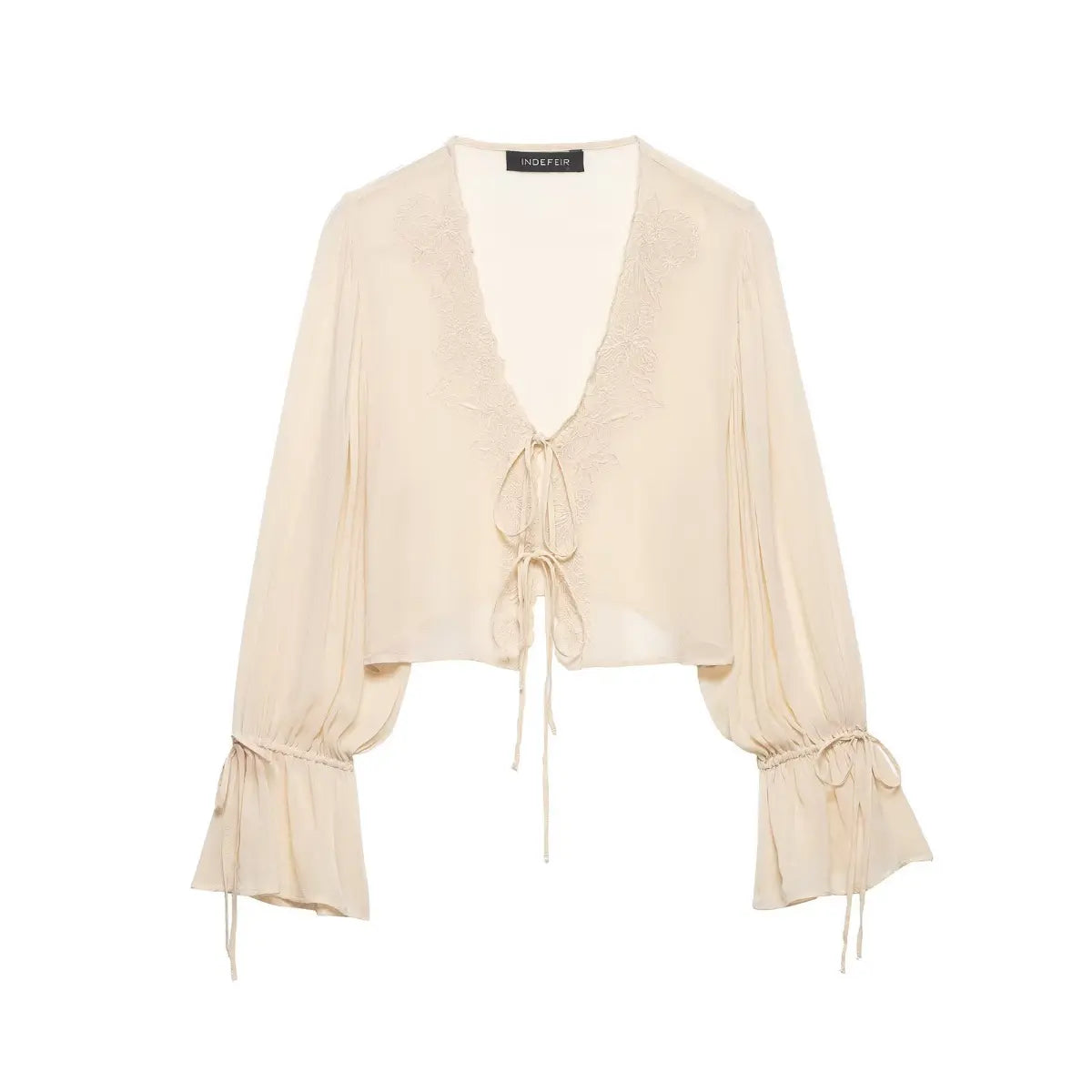 Full front flat lay of a cream chiffon blouse, showcasing lace trim, tie-front closure, and bell sleeves with drawstring cuffs.