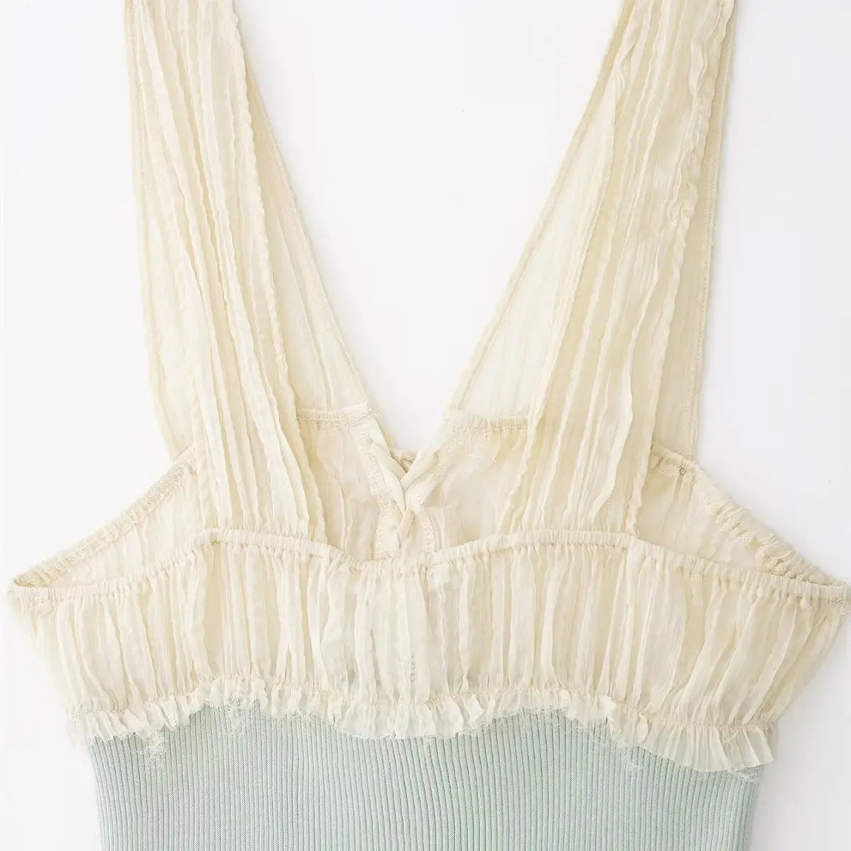 Back view of cream chiffon and mint ribbed knit cami top, highlighting the ruffled chiffon panel and contrast knit body