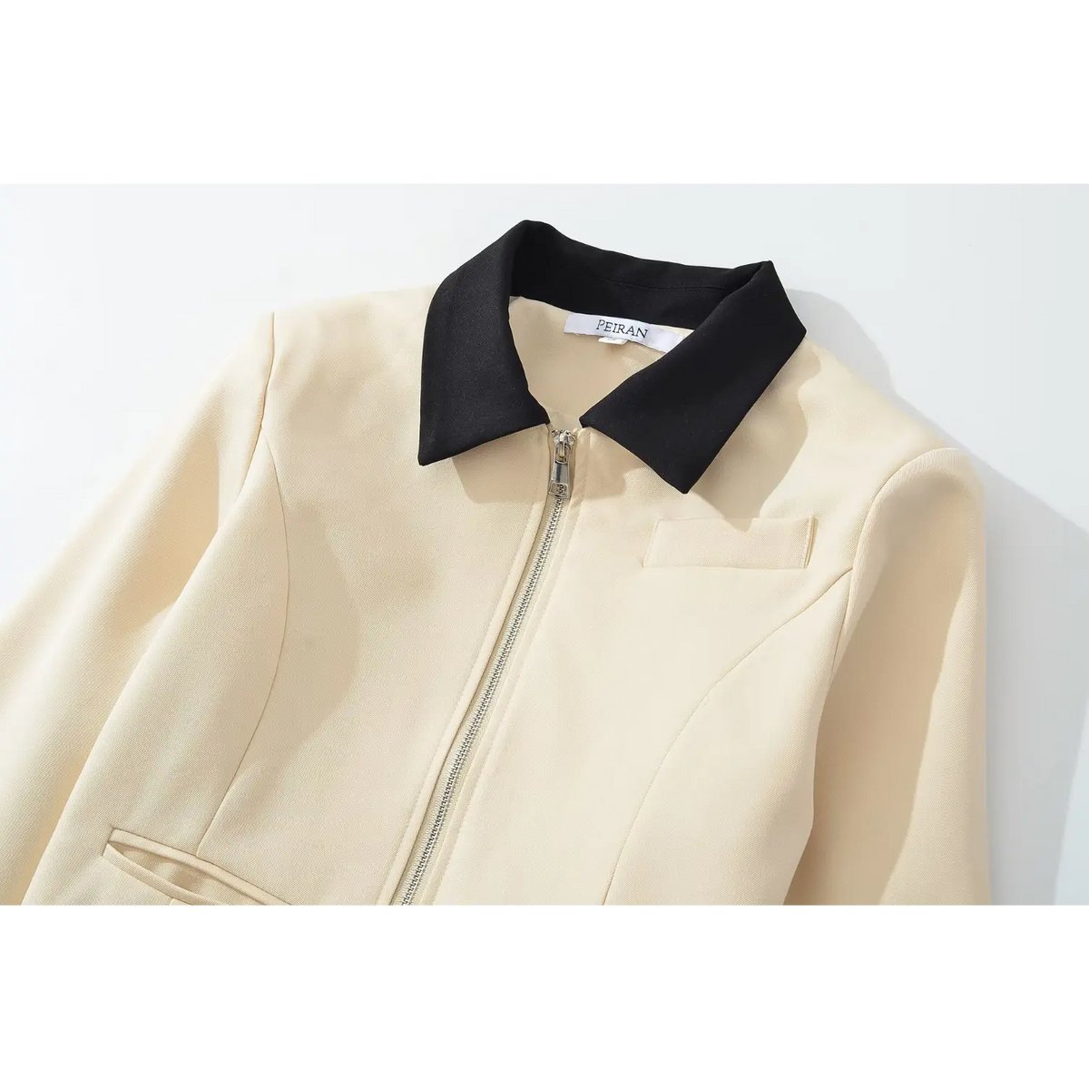 Close-up of black contrast collar and silver zipper