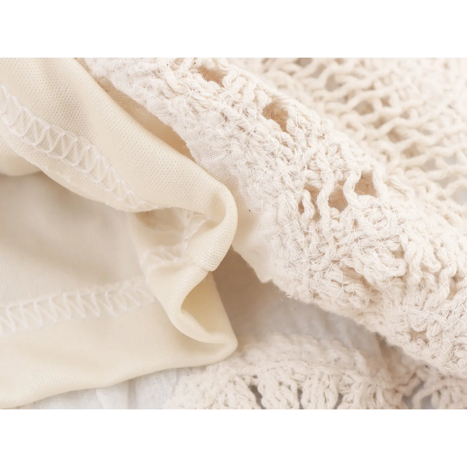 Close-up view of inner lining fabric and stitching on cream floral crochet tassel midi skirt