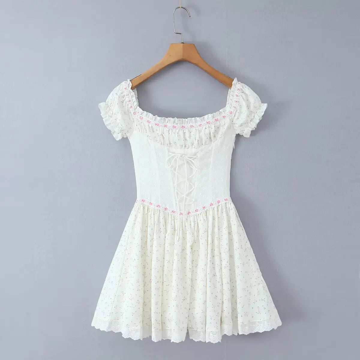 Hanging back view of the dress, showing the lace-up closure and invisible side zipper.