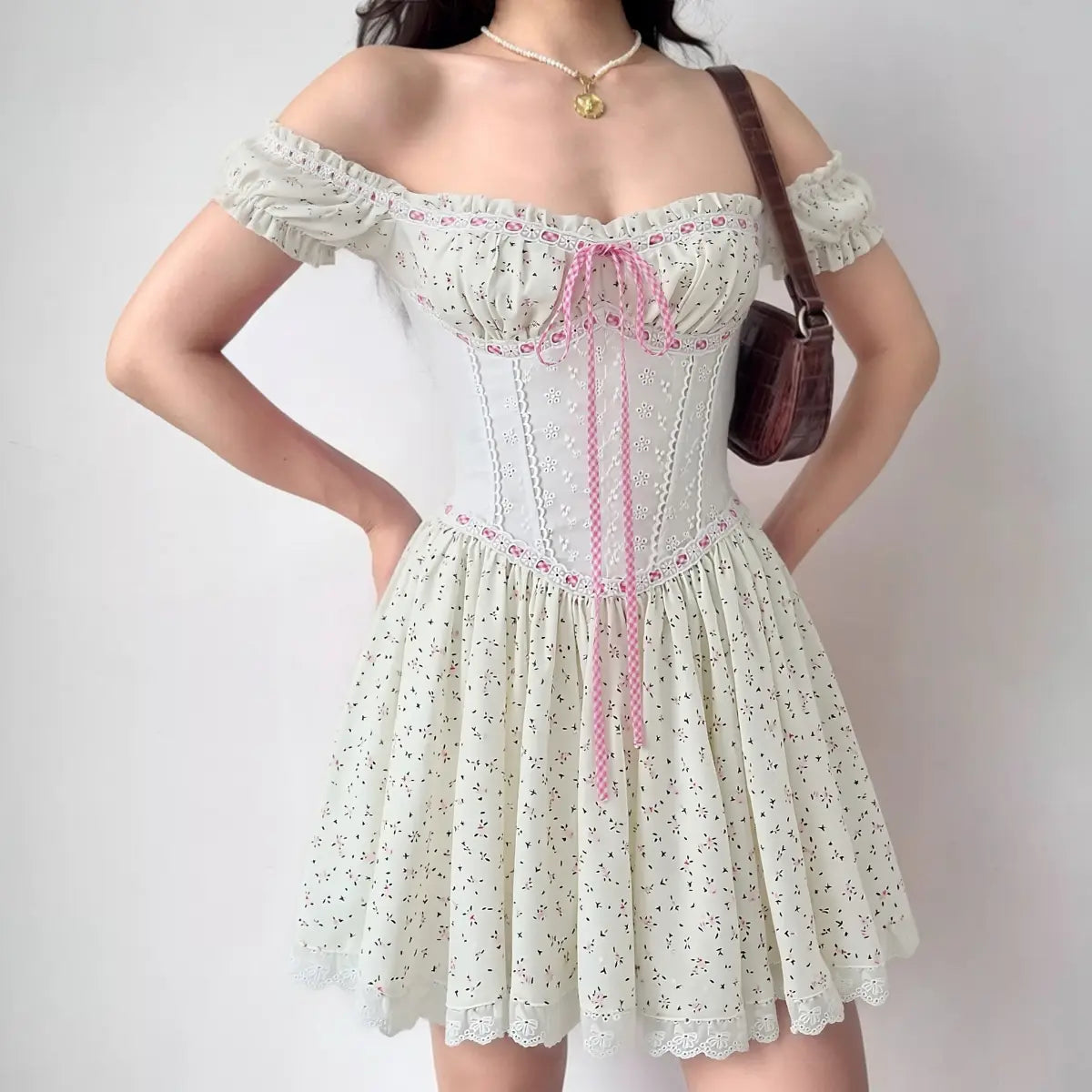 On-model view of the dress, showing the off-the-shoulder fit, corset-style bodice, and full flared skirt silhouette.