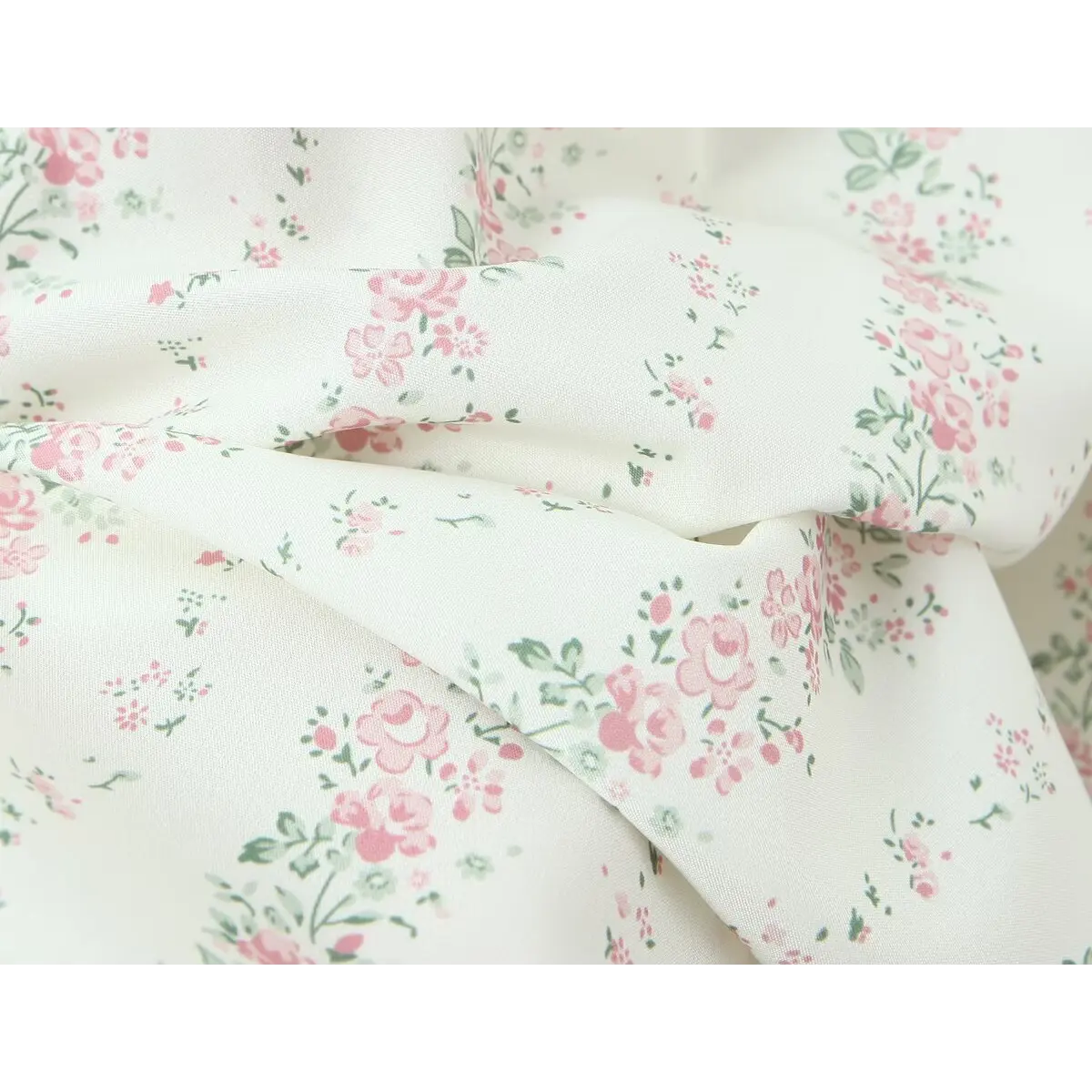 Close-up of the dress fabric, showing the soft texture and delicate pink rose ditsy print.