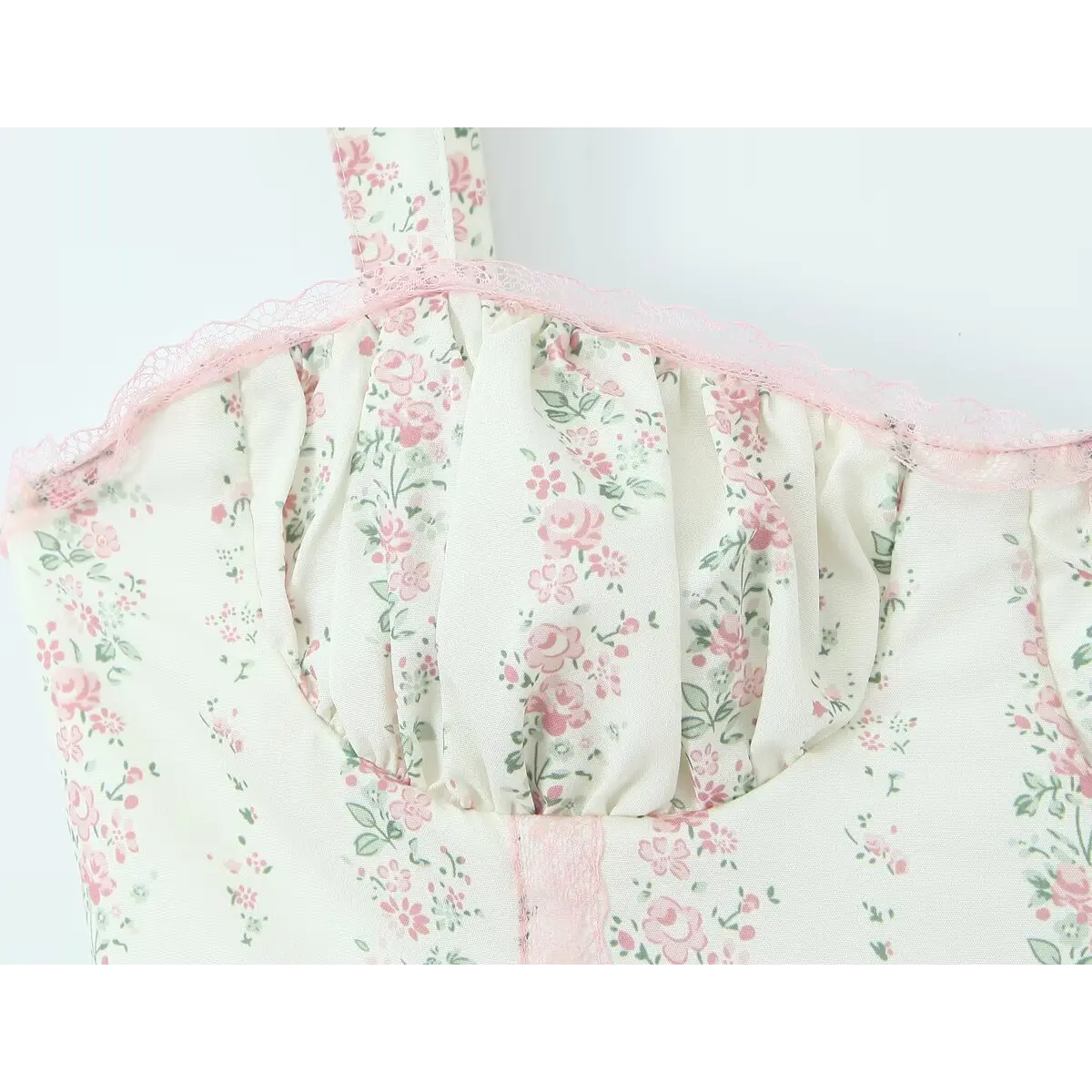 Close-up of the pink lace trim along the neckline, showing the delicate scalloped edge.